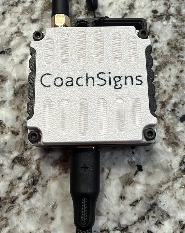 The CoachSigns base with its USB-C cable plugged into the port on its end.